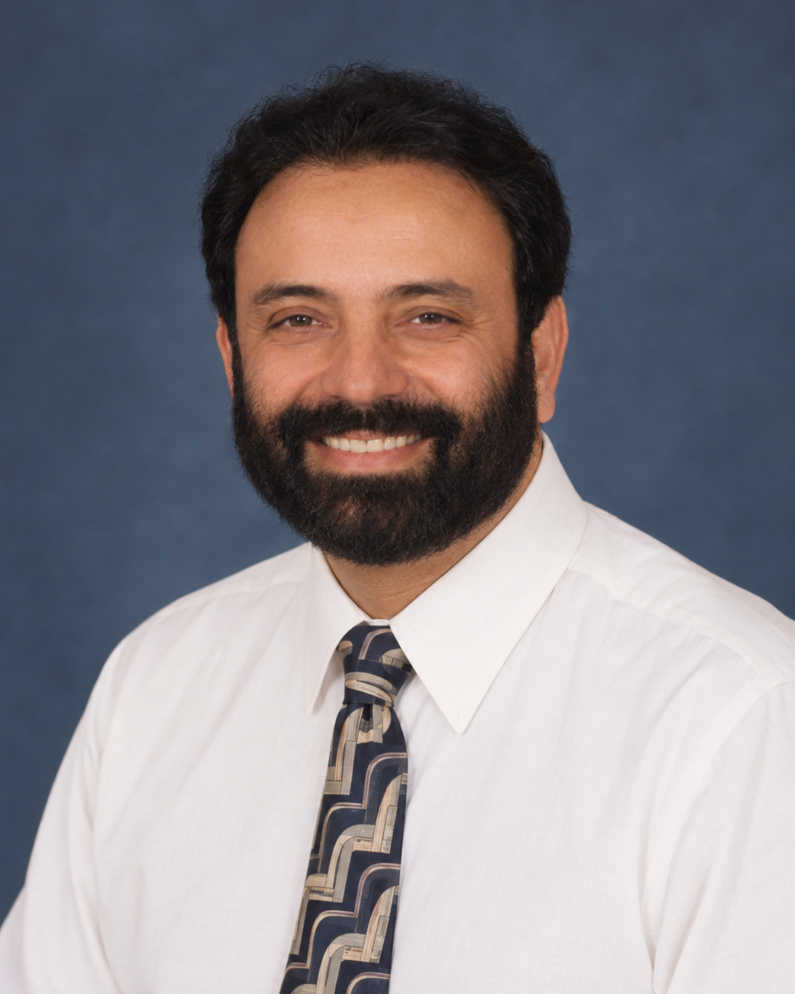 Dr. Moin U. Mallhi — AI-restored brochure portrait